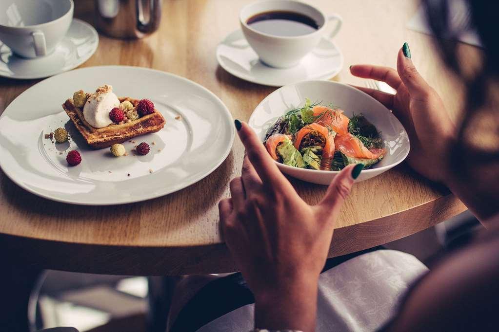 Upper House Hotel Gothenburg Restaurant photo A woman eating a meal